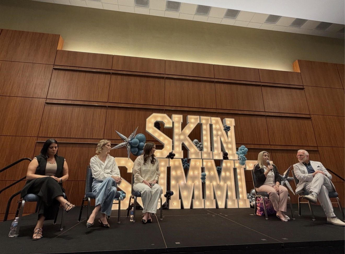 Kelly Temple speaking on an industry panel at the Skin Summit