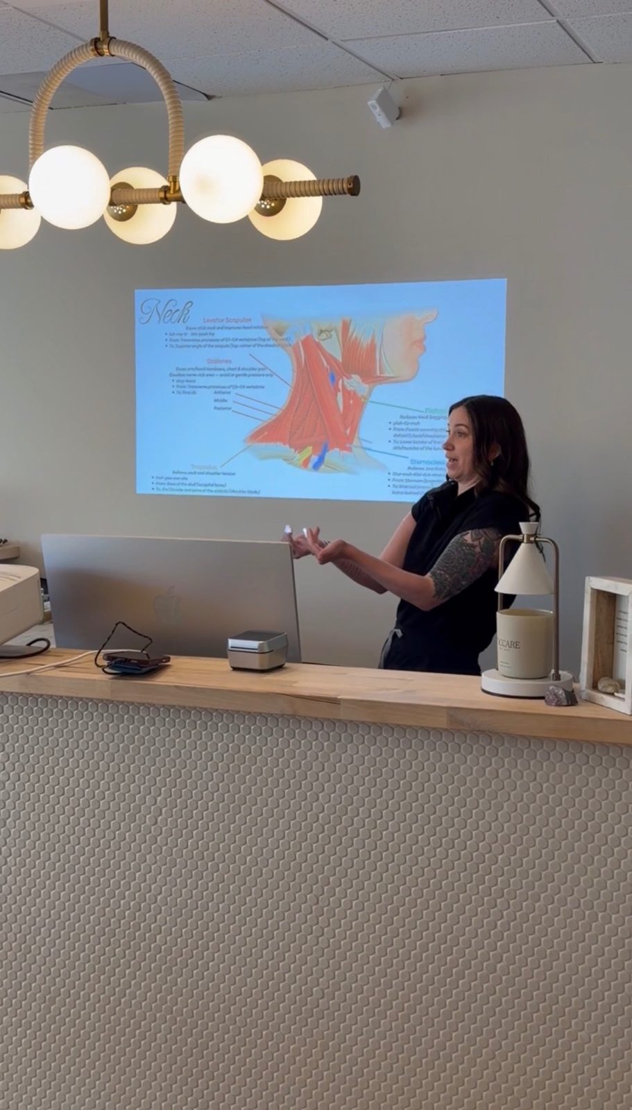 Kelly Temple teaching facial and neck anatomy to a class at TEMPLE